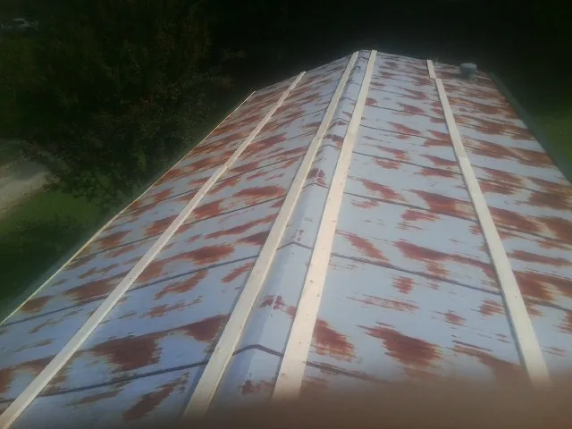 Rusted metal roof panels with new wood purlins before replacement — Storm Damage Roof Repair in Clover by Roofing Brothers